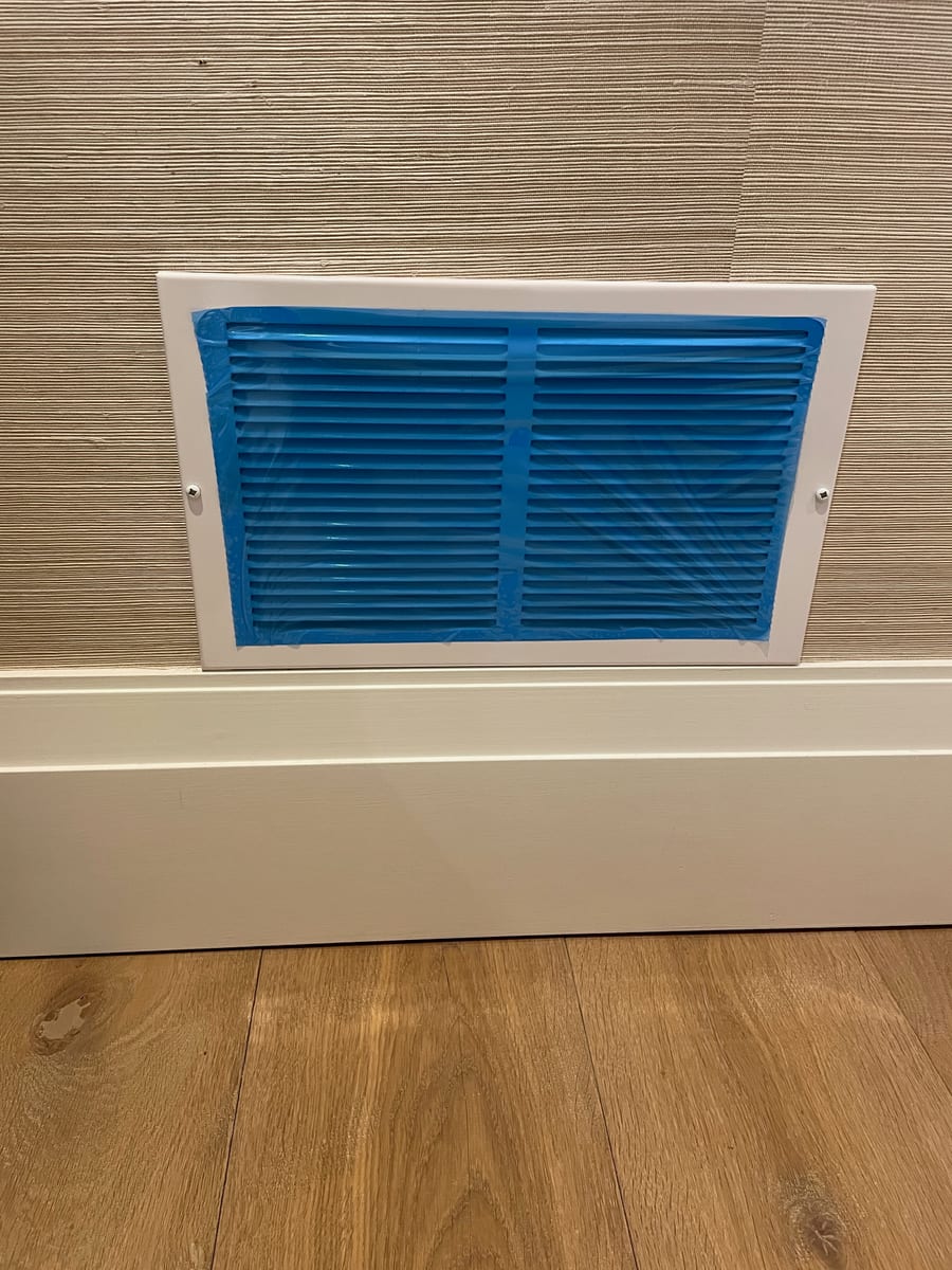 Floor vent sealed with protective film during duct cleaning